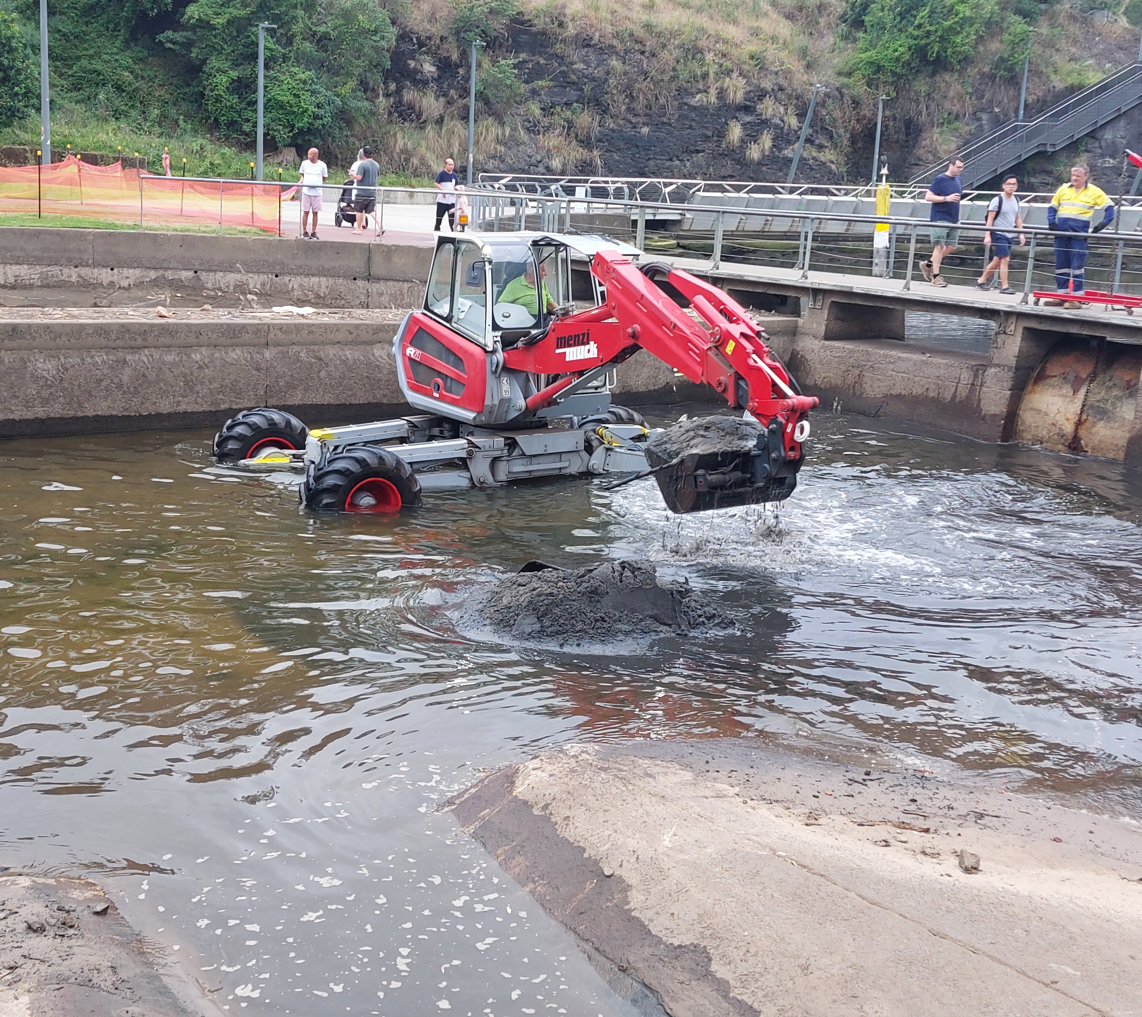 Bobcat clears silt out of the Parramatta River