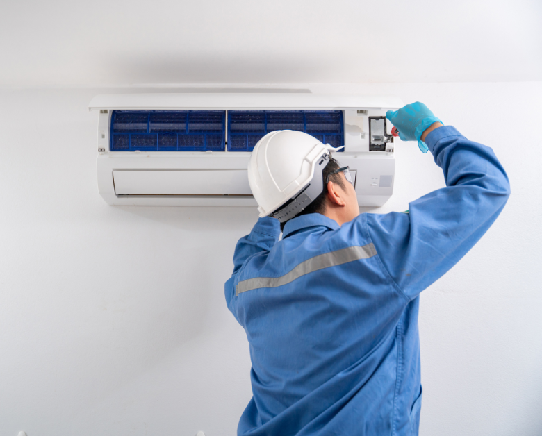 Man fixing air conditioning unit