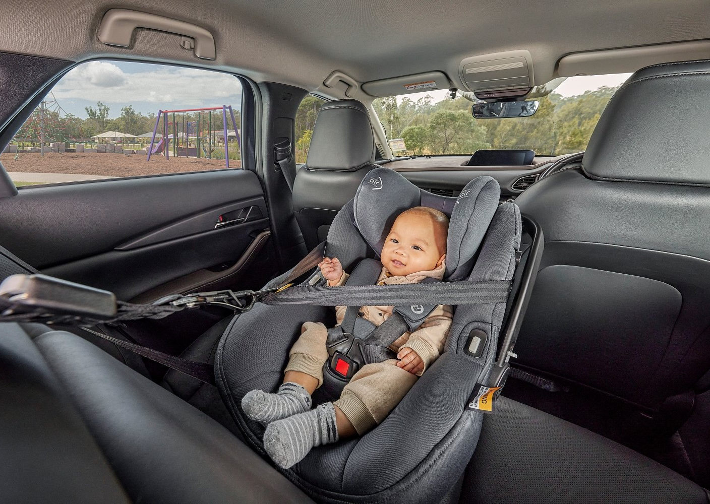 Baby sitting in grey car seat