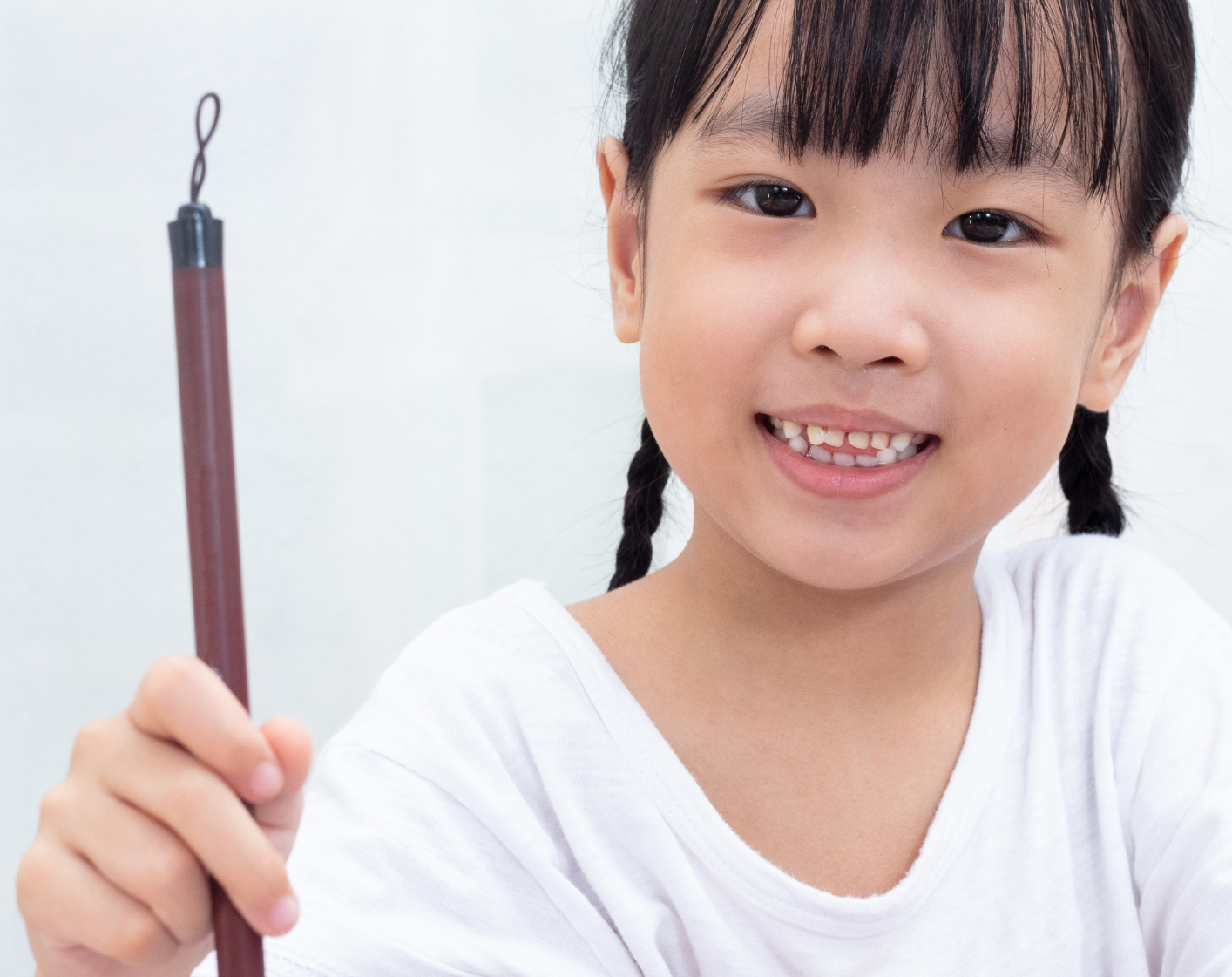 Small girl holding quill