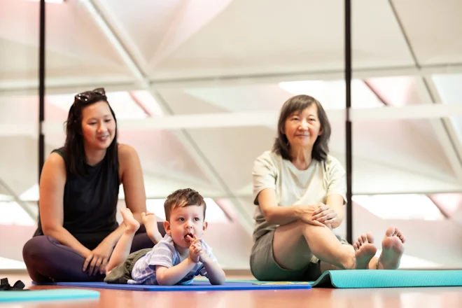 Two women and child sitting on floor in PHIVE