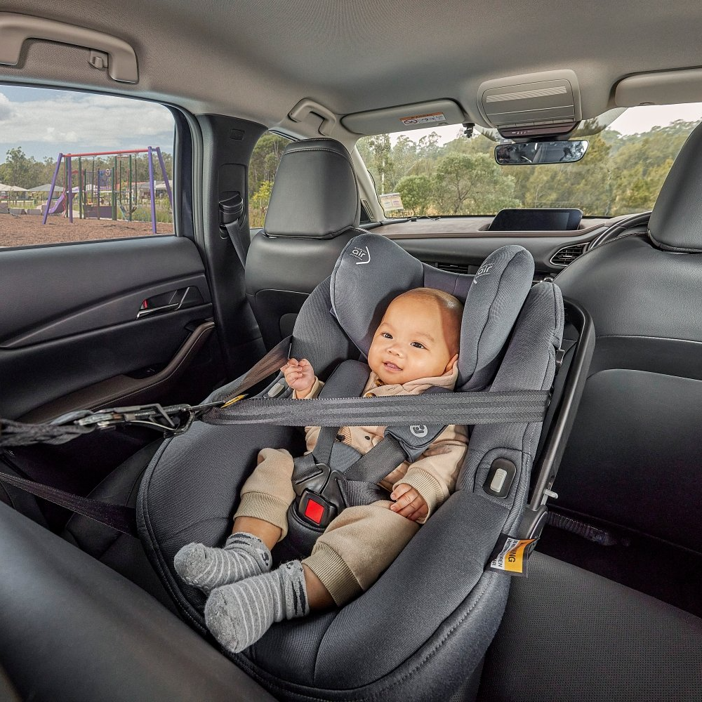 Baby sitting in grey car seat