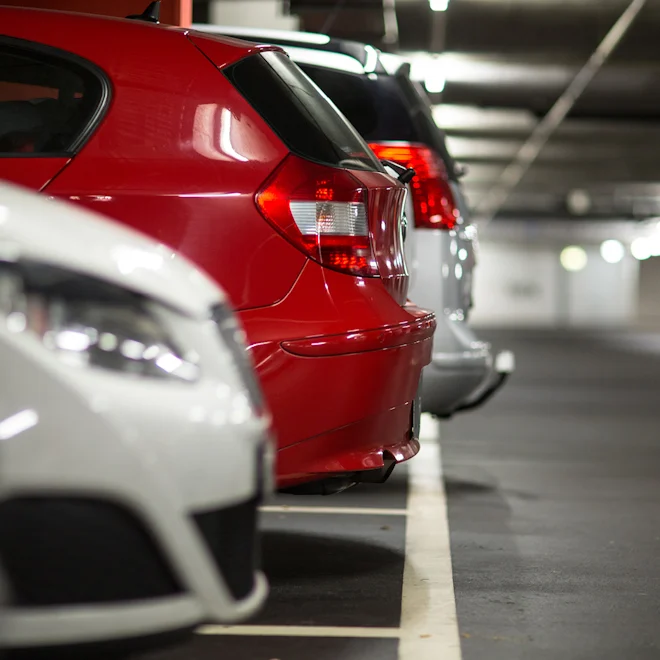 Carpark with red and white parked cars