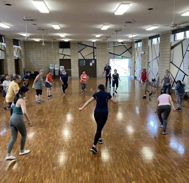Group of people exercising in a hall