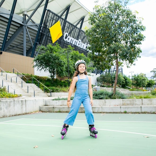 Girl on roller skates in front of CommBank Stadium