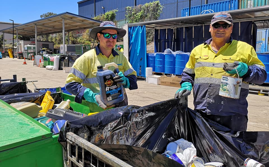 Chemical Clean Out event, two men throwing out chemicals